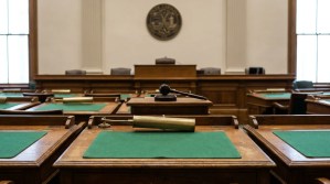 empty courtroom interior with judge's gavel, wooden benches, and official seal